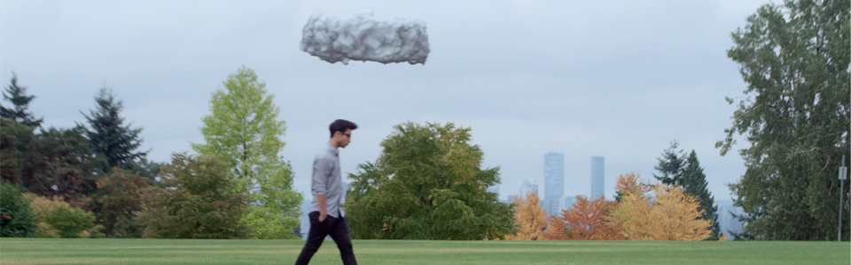 a drone disguised as a cloud hovers directly over the head of a young person walking through the park